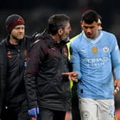 Matheus Nunes of Manchester City leaves the field with his fingers strapped up after sustaining an injury during the UEFA Champions League 2023/24 round of 16 second leg match between Manchester City and F.C. Copenhagen at Etihad Stadium on March 06, 2024 in Manchester, England. (Photo by Shaun Botterill/Getty Images)