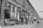 The residents of Claudia Street add the finishing touches to their decorations.