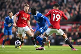 Amadou Onana of Everton is challenged by Raphael Varane