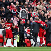 Conor Bradley of Liverpool leaves the pitch injured as Trent Alexander-Arnold of Liverpool is embraced by Jurgen Klopp, Manager of Liverpool, prior to being substituted on during the Premier League match between Liverpool FC and Crystal Palace at Anfield on April 14, 2024 in Liverpool, England. (Photo by Michael Steele/Getty Images)