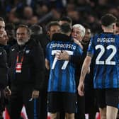 Atalanta players and head coach Gian Piero Gasperini celebrate after winning the UEFA Europa League quarter-final against Liverpool. (Photo by ISABELLA BONOTTO/AFP via Getty Images)