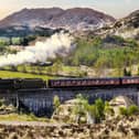 Glenfinnan Railway Viaduct in Scotland with the Jacobite steam train against sunset over lake. Image: Tomas Marek/stock.adobe