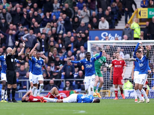 Morgan Gibbs-White of Nottingham Forest and Beto of Everton go down with an injury after competing for the ball during the Premier League match between Everton FC and Nottingham Forest at Goodison Park on April 21, 2024 in Liverpool, England. (Photo by Alex Livesey/Getty Images)