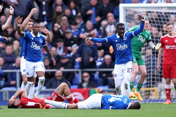 Morgan Gibbs-White of Nottingham Forest and Beto of Everton go down with an injury after competing for the ball during the Premier League match between Everton FC and Nottingham Forest at Goodison Park on April 21, 2024 in Liverpool, England. (Photo by Alex Livesey/Getty Images)