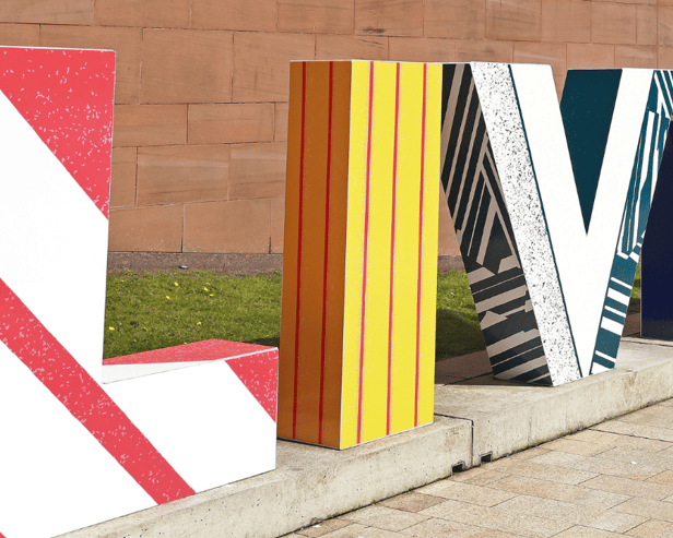 Liverpool sign gets football makeover inspired by vintage Liverpool and Everton kits.