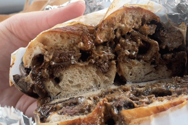 The Bagelry's Philly Cheese Steak on an onion bagel. It is filled of marinated steak and sautéed onions, peppers, mustard mayo and Bagelry cheese sauce. Image: Emily Bonner