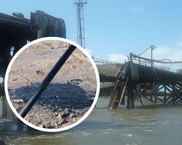 The partially collapsed pier at Rock Ferry and suspected oil spilling onto the banks of the River Mersey. Image: LDRS