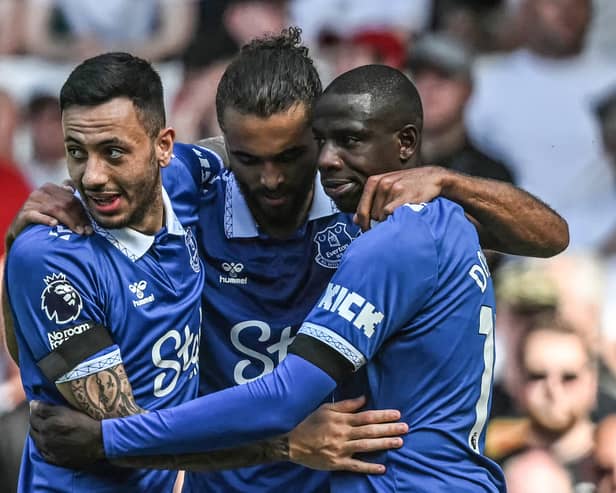 Abdoulaye Doucoure, right, celebrates opening the scoring for Everton against Sheffield United with team-mates Dwight McNeil, left, and Dominic Calvert-Lewin: (Photo by PAUL ELLIS/AFP via Getty Images)