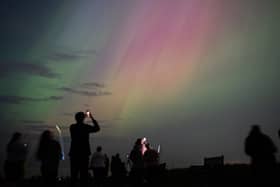 People visit St Mary's lighthouse in Whitley Bay to see the aurora borealis, commonly known as the northern lights, on May 10, 2024 in Whitley Bay, England. Photo by Ian Forsyth/Getty Images