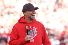 Jurgen Klopp, Manager of Liverpool, wearing a 'Thank You Luv' hoodie, speaks to the fans following his final match as Liverpool manager after the Premier League match between Liverpool FC and Wolverhampton Wanderers at Anfield on May 19, 2024 in Liverpool, England. (Photo by Clive Brunskill/Getty Images)