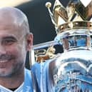Pep Guardiola celebrates with the Premier League title. (Photo by Naomi Baker/Getty Images)