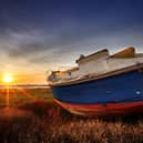 Abandoned boat during sunset on Heswall marsh coast, in the Wirral. Image: Craig Mccormick - Destructive Pixels/Wirestock Creators/stock.adobe