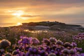 A golden sun sets behind Hilbre Island, of the coast of West Kirby, Wirral.