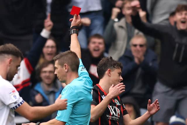 Referee, Matt Donohue shows a red card to Owen Beck of Blackburn Rovers during the Sky Bet Championship match between Preston North End FC and Blackburn Rovers FC at Deepdale on September 22, 2024 in Preston, England. (Photo by Gary Oakley/Getty Images)