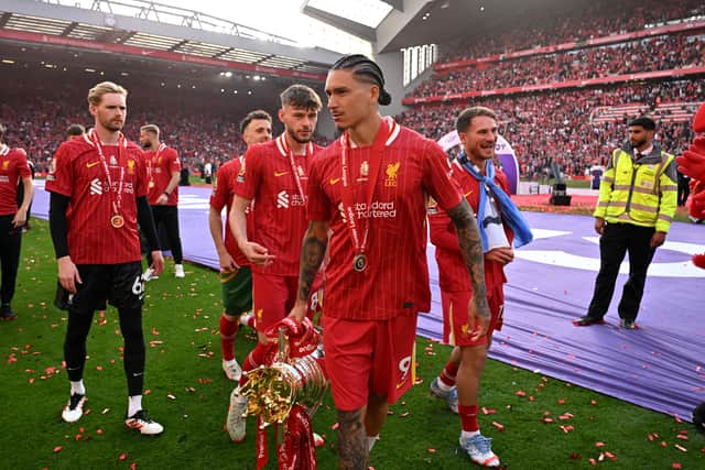 Darwin Nunez of Liverpool celebrates with the Premier League trophy, as Liverpool are crowned the Champions of the Premier League for the 2024/25 Season, following the Premier League match between Liverpool FC and Crystal Palace FC at Anfield on May 25, 2025 in Liverpool, England.