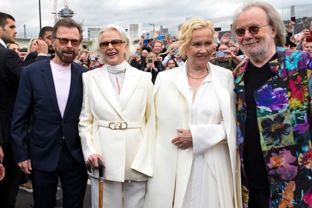 Björn Ulvaeus, Anni-Frid Lyngstad, Agnetha Fältskog and Benny Andersson say hello to the waiting fans ahead of the first performance of ABBA's "Voyage" at ABBA Arena on May 26, 2022 in London