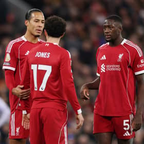 Ibrahima Konate, Virgil van Dijk and Curtis Jones of Liverpool talk to each other during the Premier League match between Liverpool and Brighton & Hove Albion at Anfield on December 13, 2025 in Liverpool, England