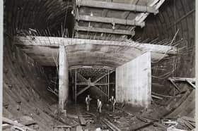 Workers standing in the bottom section of the Queensway Tunnel, Liverpool, in September 1929, beneath an experimental length of reinforced concrete, which would form the roadway.