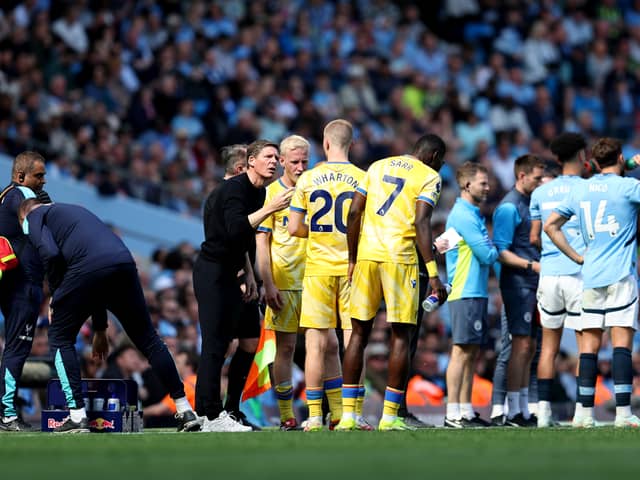 Oliver Glasner, Manager of Crystal Palace, speaks with Adam Wharton of Crystal Palace during a break in play during the Premier League match between Manchester City FC and Crystal Palace FC at Etihad Stadium on April 12, 2025 in Manchester, England. (Photo by Matt McNulty/Getty Images)