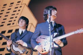 Paul McCartney (left) and John Lennon performing with The Beatles during their American tour, August 1965