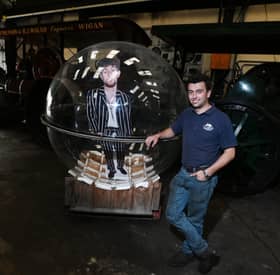 Cameron Stephenson of CJS Heritage Engineering, Wigan, pictured with a large sphere which was created and used by singer Tom Grennan's music video, All These Nights.  Tom was filmed in the huge ball, suspended from a crane in Liverpool's Royal Albert Dock. The unique item is for sale on Facebook Marketplace for £5,000.