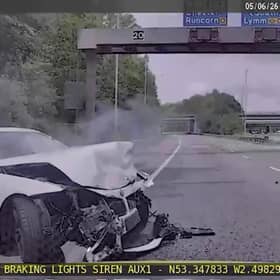 Video grab of the shocking moment a cocky boy racer speeds down a hard shoulder in a BMW before crashing into a lorry. 