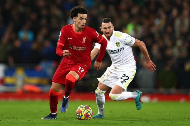 Curtis Jones gets away from Jack Harrison during Leeds United's 6-0 defeat to Liverpool at Anfield. Pic: Clive Brunskill.