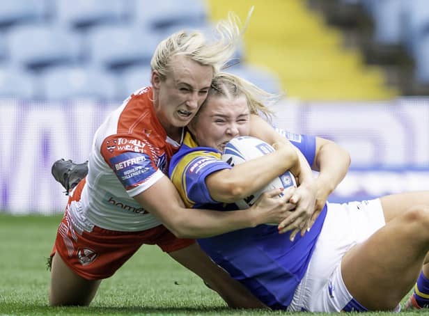 <p>St Helens's Jodie Cunningham tackles Leeds's Zoe Hornby. Picture: Allan McKenzie/SWpix.com</p>