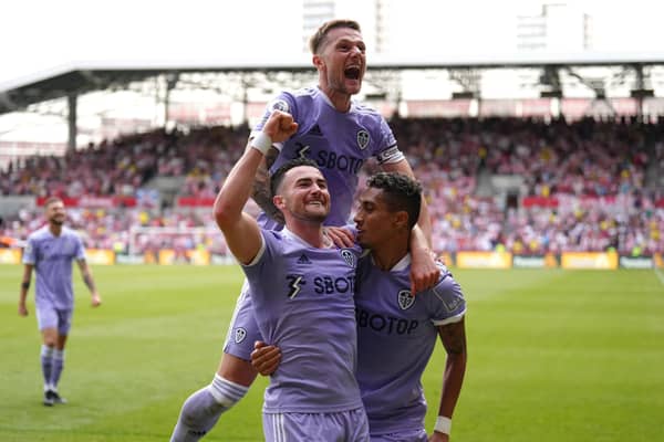 Leeds United's Jack Harrison, left, celebrates with team-mates Raphinha, right, and Liam Cooper scoring their side's second goal of the game during the Premier League match at The Brentford Community Stadium, London. (Picture: PA)