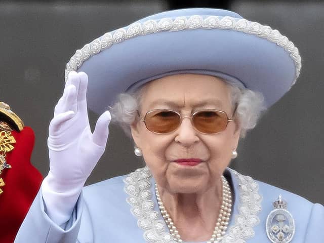 Queen Elizabeth II waves to the crowds on the balcony of Buckingham Palace.
