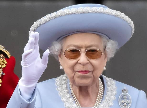 <p>Queen Elizabeth II waves to the crowds on the balcony of Buckingham Palace.</p>