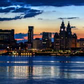 A view across the River Mersey just before the sun rises behind the Liverpool waterfront. 