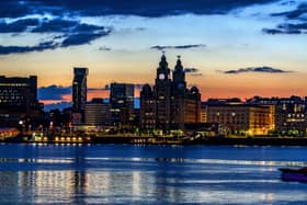 A view across the River Mersey just before the sun rises behind the Liverpool waterfront. 