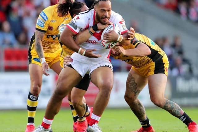 St Helens' Agnatius Paasi (centre) is tackled by Castleford Tigers' Jesse Sene-Lefao (back left) and George Griffin (right)