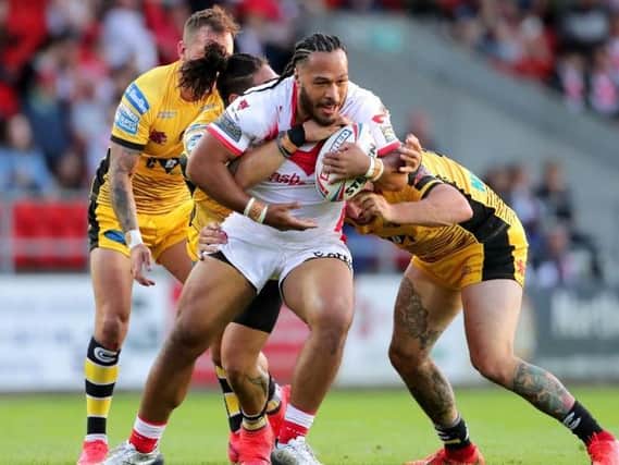 St Helens' Agnatius Paasi (centre) is tackled by Castleford Tigers' Jesse Sene-Lefao (back left) and George Griffin (right)