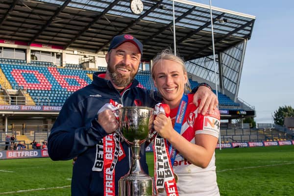 St Helens coach Derek Hardman and captain Jodie Cunningham with the Betfred Women's Super League trophy after victory over Leeds. Picture: SWPix