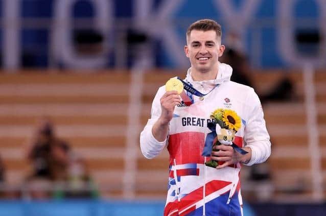 Hemel Hempstead's Max Whitlock shows off his gold medal after retaining his Olympic pommel horse title in Tokyo. Picture by Jamie Squire/Getty Images