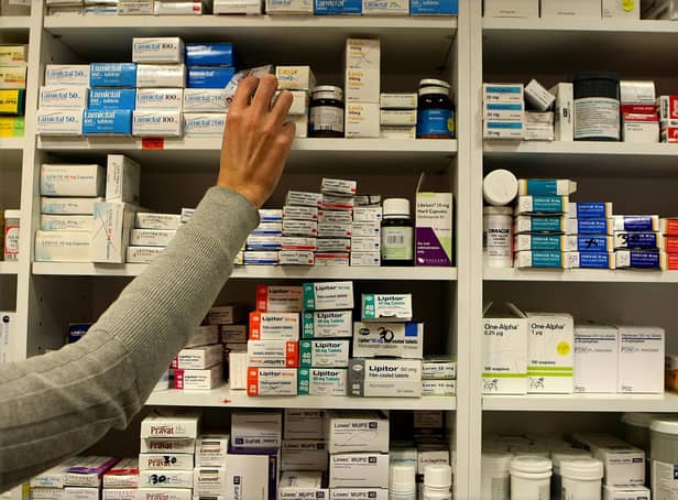A pharmacist stocks shelves at a chemist in Dublin as Health Minister Mary Harney was urged to be cautious about adding a 50 cent fee on every drug prescribed to a medical card holder as part of a range of health service savings in the Budget.