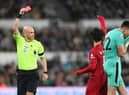 Referee Anthony Taylor shows a red card to Nick Pope of Newcastle United during the Premier League match between Newcastle United and Liverpool FC at St. James Park on February 18, 2023 in Newcastle upon Tyne, England. (Photo by Stu Forster/Getty Images)