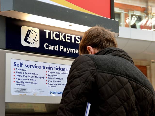File photo dated 08/12/14 of a train passenger buying a ticket at Waterloo Station in central London, as several train companies are suffering problems accepting card payments for tickets.
