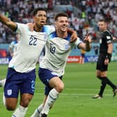 England's Jude Bellingham (left) celebrates opening the scoring against Iran with Mason Mount Picture: Clive Brunskill/Getty Images)