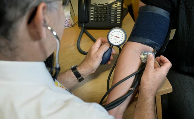 File photo dated 10/09/14 of a GP checking a patient's blood pressure. The current NHS system for seeking care "is not fit for purpose", according to a review, which recommends new neighbourhood teams to improve access for patients. Issue date: Thursday May 26, 2022.