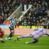 Newcastle United's English striker Callum Wilson shoots the ball but Liverpool's Brazilian goalkeeper Alisson Becker (R) stops the ball during the English Premier League football match between Newcastle United and Liverpool at St James' Park in Newcastle-upon-Tyne, north east England on February 18, 2023. (Photo by OLI SCARFF/AFP via Getty Images)