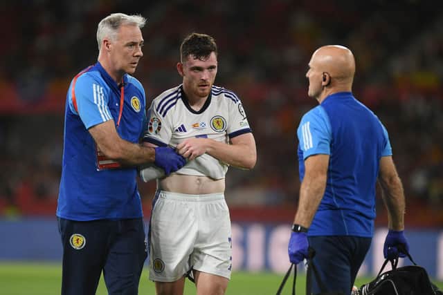 Scotland captain Andrew Robertson leaves injured following a clash with Spain goalkeeper Unai Simon. (Photo by JORGE GUERRERO / AFP) (Photo by JORGE GUERRERO/AFP via Getty Images)