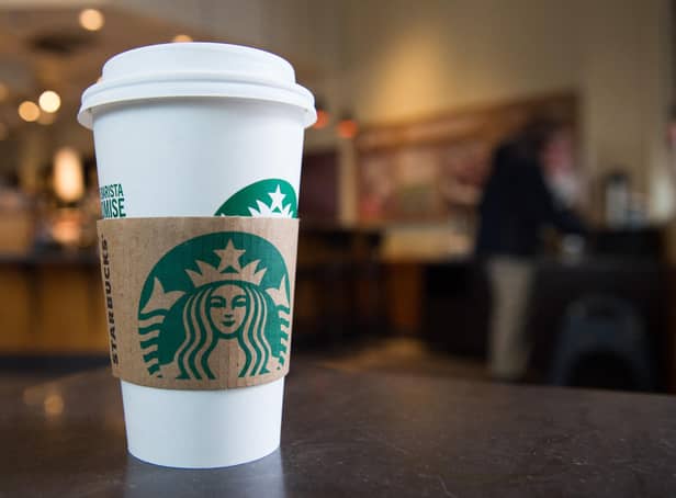 <p>A Starbucks coffee cup (Photo by SAUL LOEB/AFP via Getty Images)</p>