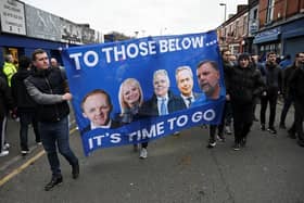 UNPOPULAR: Everton fans protests forced the departures of Grant Ingles, Denise Barrett-Baxendale (left and second left) and Graham Sharp (far right) - all pictured on this banner - as directors. Owner Farhad Moshiri is second from the right