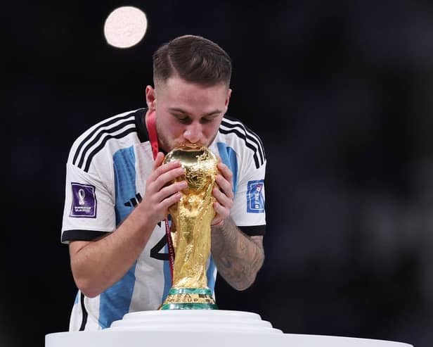 Alexis Mac Allister of Argentina kisses the FIFA World Cup Qatar 2022 Winner's Trophy during the FIFA World Cup Qatar 2022 Final match between Argentina and France at Lusail Stadium on December 18, 2022 in Lusail City, Qatar. (Photo by Clive Brunskill/Getty Images)