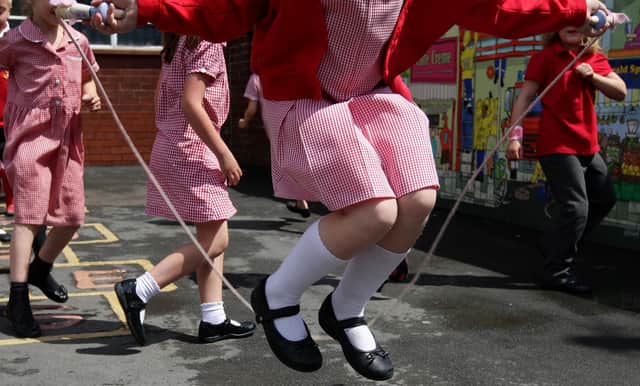 Children at St. George's C of E Primary School in Stockport, skip and play hop scotch during playtime.