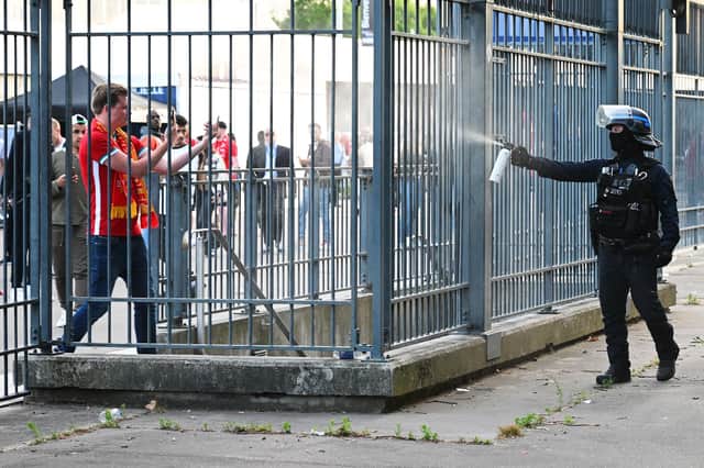 Police spray tear gas at Liverpool fans outside the stadium ahead of the Champions League final between Liverpool and Real Madrid (Picture: Matthias Hangst/Getty Images)