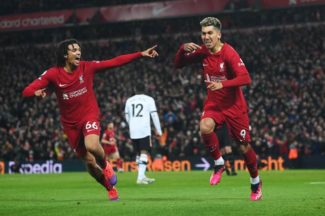 LIVERPOOL, ENGLAND - MARCH 05: Roberto Firmino of Liverpool celebrates after scoring the team's seventh goal with teammate Trent Alexander-Arnold during the Premier League match between Liverpool FC and Manchester United at Anfield on March 05, 2023 in Liverpool, England. (Photo by Michael Regan/Getty Images)